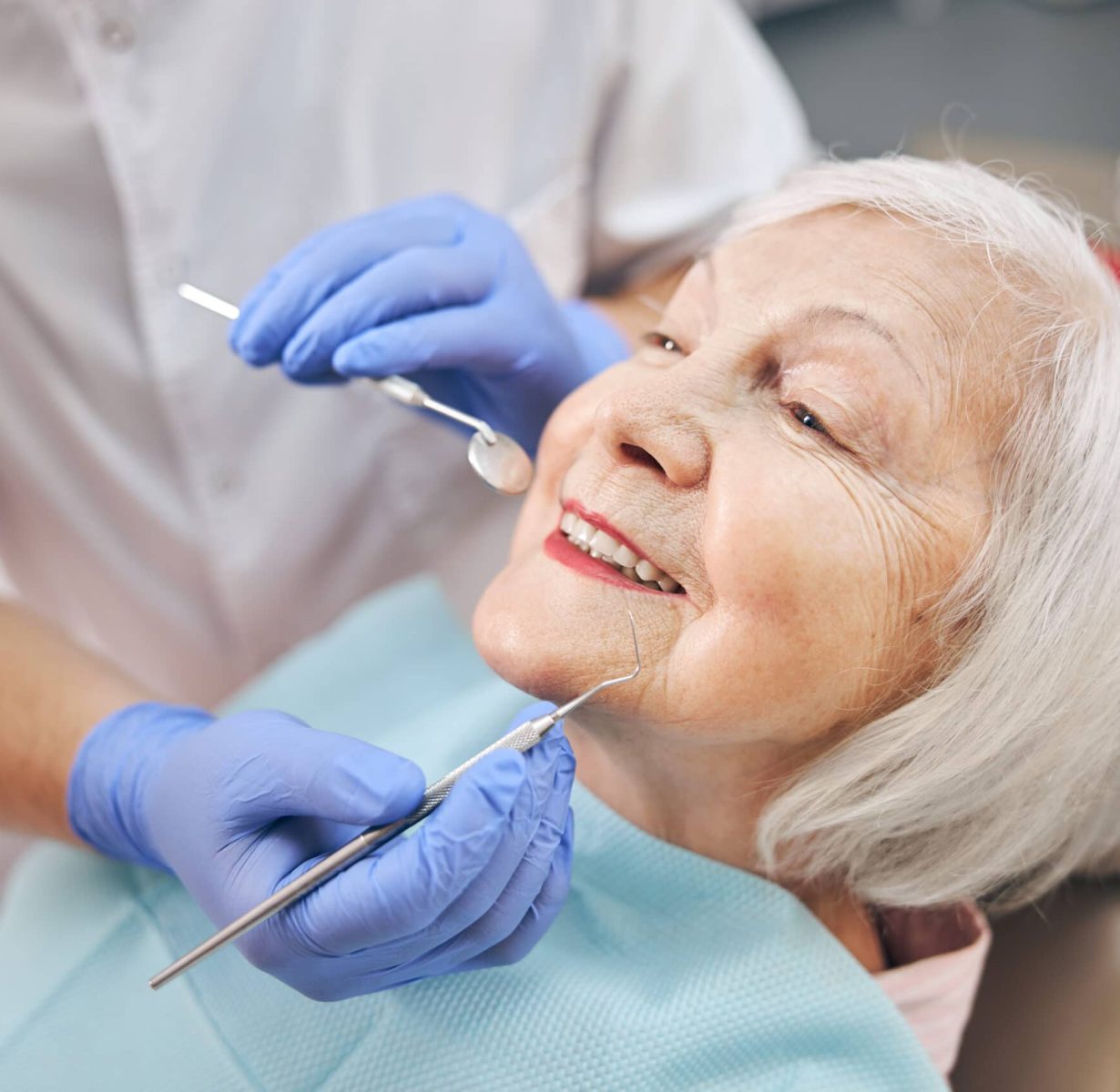close-up-portrait-elderly-beautiful-woman-check-up-having-consultation-with-dentist-dental-office-scaled